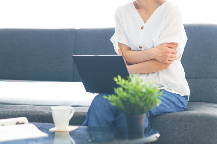 もう夏でも手足が冷たいとは言わせない! 冷えの原因を徹底解剖 ソファに座る女性、冷えている体