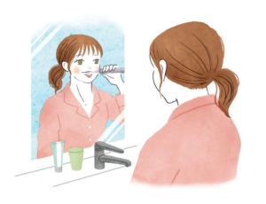 洗面所で歯磨きをする女性のイラスト
